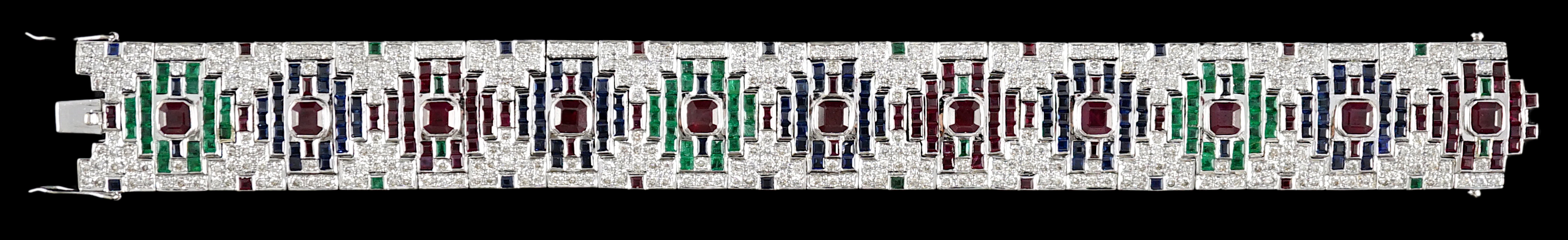 An attractive late 20th century 18k white gold, ruby, sapphire, emerald and diamond set bracelet